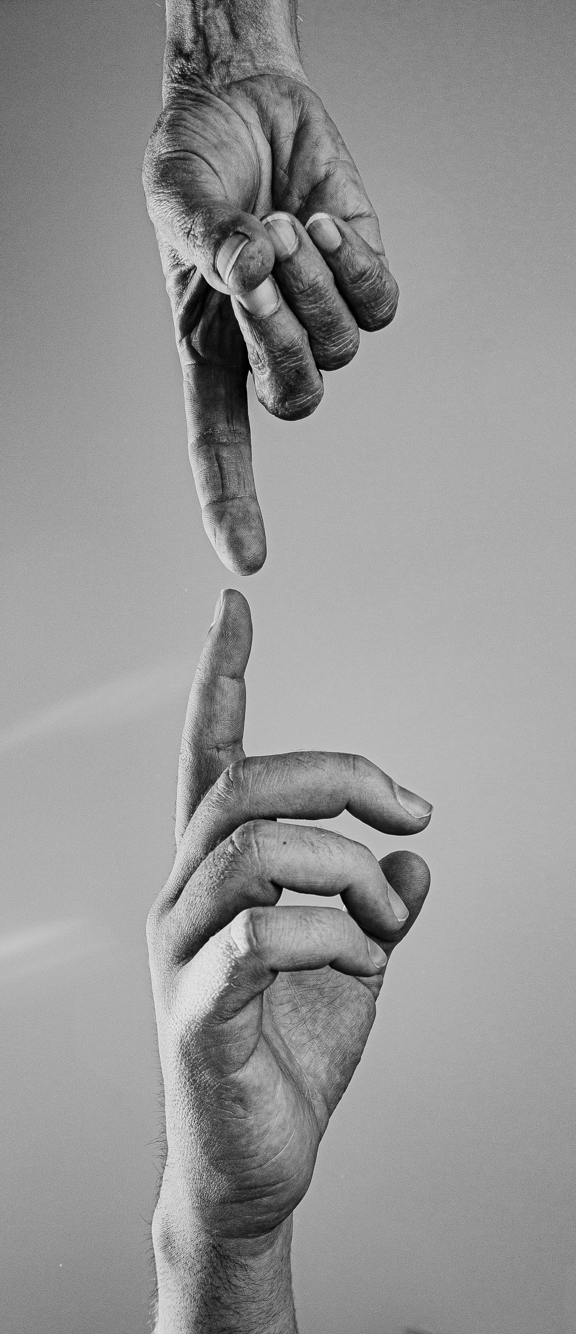 two-reaching-hands-in-black-and-white